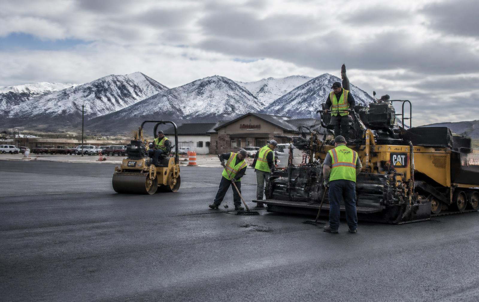 Summit Surface paving crew placing hot mix asphalt on a commercial lot near Eureka, MT